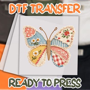 May include: A colorful butterfly DTF (Direct to Film) transfer, ready to press. The butterfly design features patchwork patterns in pink, blue, yellow, and red, with floral and daisy accents. The text "DTF TRANSFER" and "READY TO PRESS" are displayed.