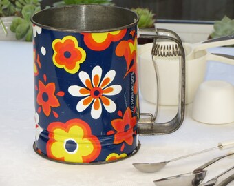 1970's Kande Flour Sifter with blue background with orange and yellow flowers, Made in Australia