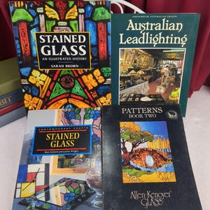 May include: Four books on stained glass and leadlighting. Titles include Stained Glass An Illustrated History by Sarah Brown, Australian Leadlighting, Contemporary Crafts Stained Glass by Marc Gerstein and Lynette Wrigley, and Patterns Book Two by Allen Kenoyer Glass.