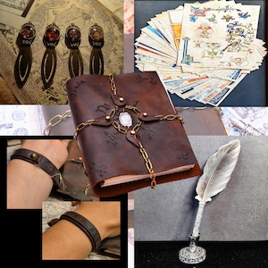 May include: A brown leather journal with a metal chain and a crystal charm. The journal is closed and has a worn look. There are also four bookmarks with glass insets and a quill pen with a silver holder.