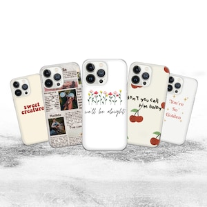 May include: Five phone cases with different designs. One is cream-coloured with the words "sweet creature" in red. Another has a newspaper-style design. A third case is white with flowers and the words "we'll be alright". The fourth case has cherries and the words "don't you call him baby". The last case is white with the words "You're So Golden".