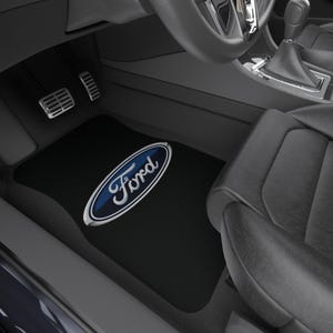 May include: Black car floor mats with the Ford logo in a blue oval with a silver outline.