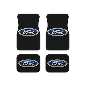 May include: Set of four black floor mats with the Ford logo in blue and silver.