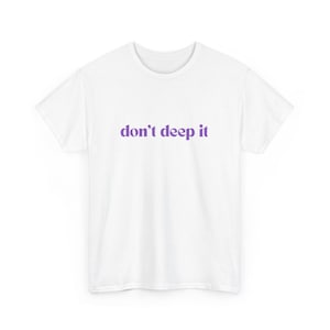 May include: White t-shirt with purple text that reads "don't deep it"
