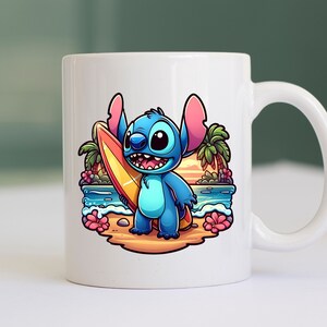 May include: A white ceramic mug with a blue and pink cartoon character holding a yellow surfboard. The character is standing on a beach with palm trees and a sunset in the background.