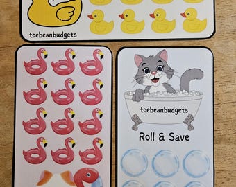 May include: Three sticker sheets with cute illustrations. One sheet features a white cat on a yellow duck, and yellow ducks. Another sheet has pink flamingo floaties. The last sheet shows a gray cat in a bathtub with bubbles and the text "Roll & Save".