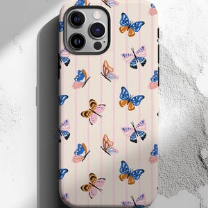 May include: A phone case with a cream background and pink vertical stripes. The case is decorated with a repeating pattern of colorful butterflies in shades of blue, orange, pink, and black.