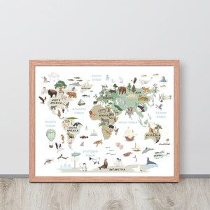 May include: A framed world map print with a light wood frame. The map features a pastel color palette with illustrations of animals and landmarks. The continents are labeled, and the oceans are identified.