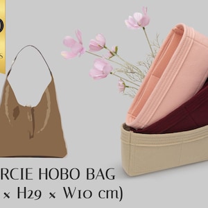 May include: A brown hobo bag with a zipper closure. The bag is 36 cm long, 29 cm high, and has a width of 10 cm. The bag is shown with a beige, pink, and burgundy felt bag organiser.