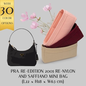 May include: Black leather shoulder bag with a gold buckle and a gold logo. The bag is 22 inches long, 18 inches high, and 6.5 inches wide. The bag is shown with three fabric inserts in pink, burgundy, and beige.