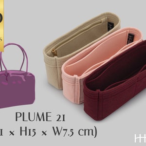 May include: A purple felt bag insert for a handbag, with the text "PLUME 21 (L21 x H15 x W7.5 cm)" below. Three different color felt bag inserts are shown in the background: beige, pink, and burgundy.