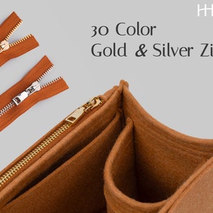 May include: An image showcasing a brown felt organizer with gold zippers. The image also displays three separate brown zippers with gold and silver metal teeth. Text reads "30 Color Gold & Silver Zips!"
