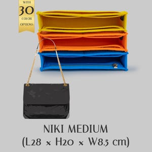 May include: A black patent leather handbag with a gold chain strap, next to a stack of colorful felt organizers. The organizers are yellow, orange, and blue. The bag is labeled "NIKI MEDIUM" and measures 11 x 7.9 x 3.3 inches.