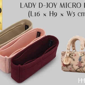 May include: Three felt bag organizers in beige, pink, and burgundy. The organizers are designed to fit a Lady D-Joy Micro Bag, which is shown in the image. The bag is beige with a floral pattern and measures 16 inches long, 9 inches high, and 5 inches wide.
