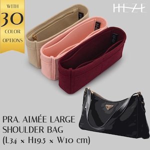 May include: Three felt bag organisers in beige, pink, and burgundy. The organisers are designed to fit inside a Prada Aimée Large Shoulder Bag. The bag organisers are available in 30 colours. The text "HEZE" is visible in the top right corner of the image.
