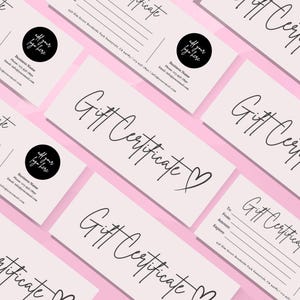 May include: A set of pink gift certificates with the text "Gift Certificate" in black cursive writing. The certificates have a black circle with the text "All your logo here" in white.