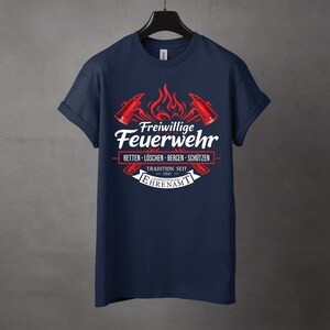 May include: Navy blue t-shirt with a graphic featuring the words "Freiwillige Feuerwehr" in white, along with red axes and flames. The text "RETTEN - L&Ouml;SCHEN - BERGEN - SCH&Uuml;TZEN" is also present, along with "TRADITION SEIT 1841".
