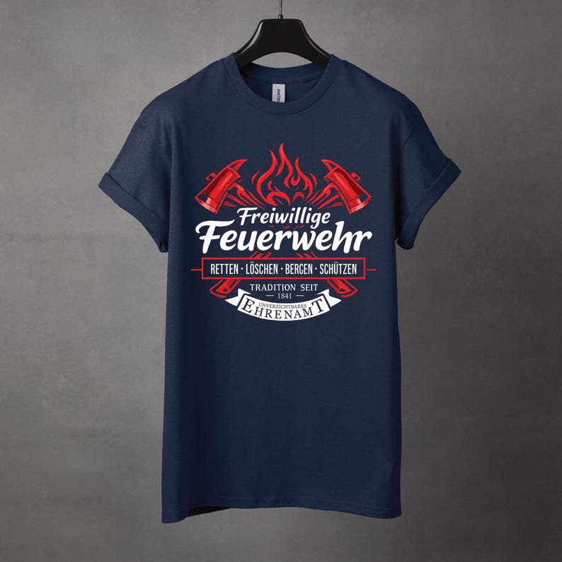 May include: Navy blue t-shirt with a graphic featuring the words "Freiwillige Feuerwehr" in white, along with red axes and flames. The text "RETTEN - L&Ouml;SCHEN - BERGEN - SCH&Uuml;TZEN" is also present, along with "TRADITION SEIT 1841".