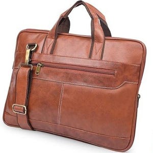 May include: A brown leather briefcase with a top handle and a detachable shoulder strap. The bag features a front zipper pocket, a main compartment zipper, and white stitching details. The hardware is gold-colored.