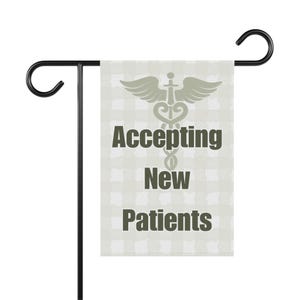 May include: A rectangular garden flag hanging on a black metal stand. The flag features a light gray and white checkered pattern with a dark gray caduceus symbol and the text "Accepting New Patients" printed in dark gray block lettering.