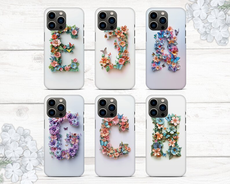 May include: Six white iPhone cases with floral designs and letters. Each case features a different letter of the alphabet, from A to G, made of colorful flowers and butterflies.