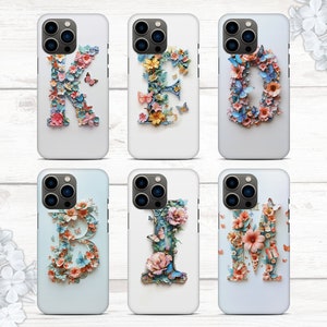 May include: Six iPhone cases with floral designs and letters K, I, M, B, E, and I. The cases are white with a clear plastic back and a floral design that spells out the word "KIMBIE".