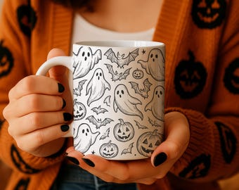 May include: White ceramic mug featuring a black and white Halloween pattern of ghosts, bats, and jack-o'-lanterns. The mug has a white handle and is designed for hot beverages. A festive item for the spooky season.