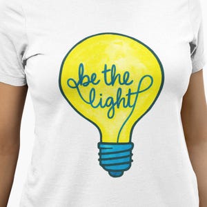 Be the Light Shirt – Inspirational Light Bulb T-Shirt, Motivational Quote Positive Vibes Unisex Tee, Uplifting Gift for Adults,Youth,Toddler