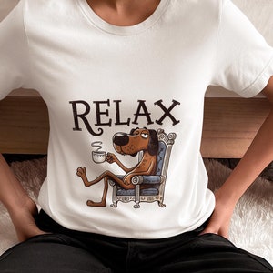 Relaxing Cartoon Dog with Coffee Unisex T-Shirt, Chill Dog Novelty Shirt Design, Relaxation Tee, Cozy Coffee Lover Top Gift Idea for Her/Him