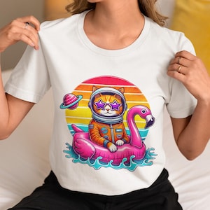 Astronaut Cat Flamingo Float T-Shirt, Retro Space Cat Beach Tee with Star Glasses & Sunset, Galaxy Vacation Shirt, Unisex Cosmic Summer Gift