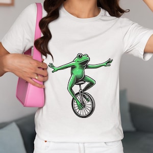 Whimsical Frog Riding Unicycle Unisex T-Shirt, Fun Amphibian Lover Novelty Tee,Perfect Shirt Gift Idea for Circus Art Fans Top & Unicyclists