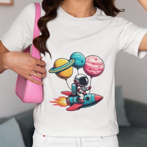 Colorful Astronaut Riding Rocket with Planet Balloons T-Shirt - Unisex Space Adventure Tee - Fun Space Explorer Gift Top Idea