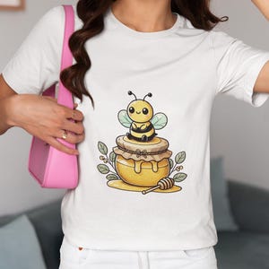 Kawaii Bee Sitting on Honey Pot T-Shirt, Cute Bumblebee with Honey Jar Graphic Novelty Tee, Perfect Top Gift for Bee Lovers and Honey Shirt