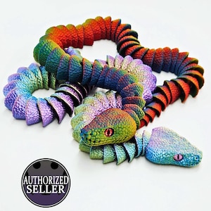 May include: A vibrant, articulated snake toy in a rainbow of colours. The snake's head is intricately designed with red eyes. The body is segmented, enabling flexible movement. The image includes an "AUTHORIZED SELLER" logo.