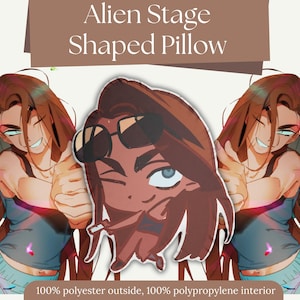 May include: A shaped pillow with a cartoon illustration of a person wearing sunglasses and winking. The pillow has a brown and tan color scheme. The text "Alien Stage Shaped Pillow" is at the top. The pillow is made of 100% polyester outside and 100% polypropylene interior.