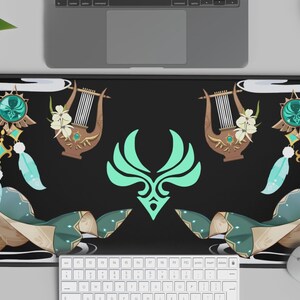 May include: Black rectangular desk mat featuring a teal and gold design with a central emblem and decorative elements. The mat includes a keyboard, mouse, and laptop, suitable for a home office or gaming setup.