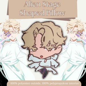 May include: A shaped pillow with a cartoon illustration of a character with blonde hair and a white outfit. The pillow has the text "Alien Stage Shaped Pillow" at the top. The pillow is made of 100% polyester outside and 100% polypropylene interior.