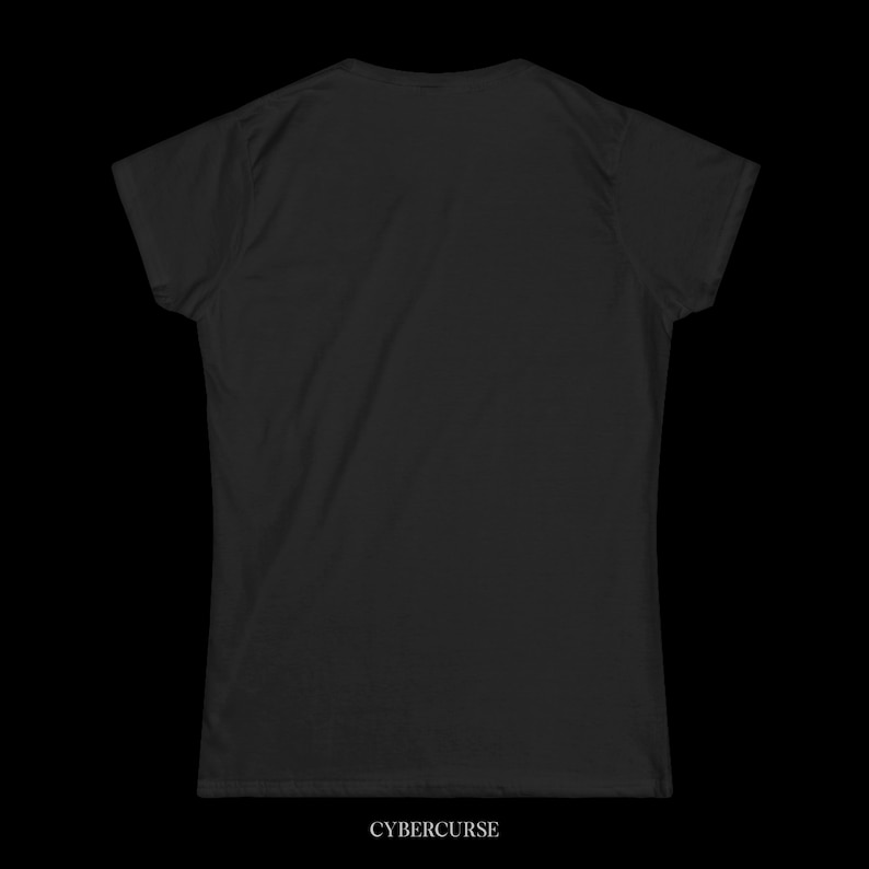 May include: A black t-shirt with a crew neck and short sleeves. The text "CYBERCURSE" is printed in white at the bottom of the shirt. The shirt is made of a soft material and is displayed against a black background.