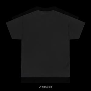 May include: Three black t-shirts are stacked on top of each other against a black background. The bottom shirt has the word "CYBERCURSE" printed in white at the bottom.