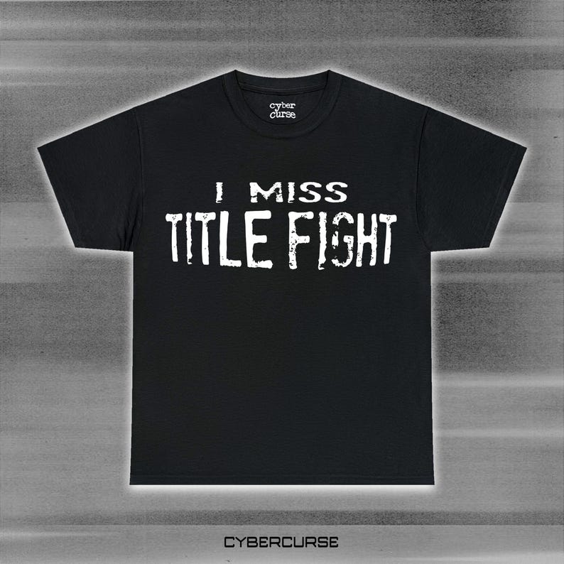May include: Black t-shirt with white text that reads "I miss Title Fight" and a small "cyber curse" logo in the top center.