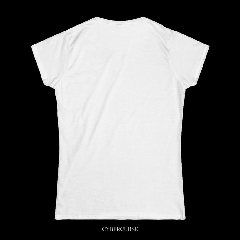 May include: A white t-shirt with a crew neck and short sleeves. The text "CYBERCURSE" is printed in a sans-serif font at the bottom of the shirt. The shirt is made of a soft, likely cotton, material.