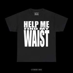 May include: Black t-shirt with the text "HELP ME FIND MY WAIST" in bold white letters. The brand name "cyber curse" is printed above the text and below the text. The shirt is made of a soft material.
