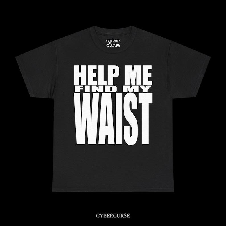 May include: Black t-shirt with the text "HELP ME FIND MY WAIST" in bold white letters. The brand name "cyber curse" is printed above the text and below the text. The shirt is made of a soft material.