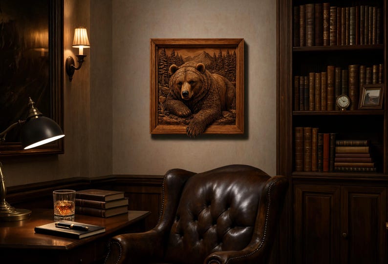May include: A square wooden wall art piece featuring a three-dimensional relief carving of a brown bear resting in a forest setting. The bear is depicted with detailed fur texture, positioned against a backdrop of carved pine trees and mountains.
