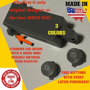 May include: A gray plastic latch with a black button. The latch has a stronger ear design with a much more durable material than plastic. The text "MADE IN USA" is visible in the image. The text "3 COLORS" is also visible in the image. The text "STRONGER EAR DESIGN WITH A MUCH MORE DURABLE MATERIAL THAN PLASSTIC" is visible in the image. The text "SAME DAY SHIPPING ORDER BY 2 PM SAME DAY SHIPPING" is visible in the image. The text "FREE BUTTONS WITH EVERY LATCH PURCHASE!!" is visible in the image.