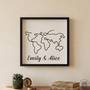 May include: A black framed print with a minimalist black line drawing of a world map on a white background. The names "Emily & Alice" are printed in black script below the map. The frame is black.
