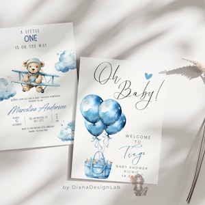 May include: Two baby shower invitations with blue and white watercolor designs. The first invitation features a teddy bear in a blue airplane flying through clouds. The second invitation features blue balloons tied to a blue tote bag with a teddy bear inside. The text on the invitations reads "A little one is on the way" and "Oh Baby! Welcome to Tiago Baby Shower Picnic 14.06".