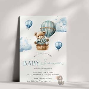 May include: A blue and white hot air balloon with a teddy bear inside. The balloon is surrounded by clouds and stars. The text "Please join us for a baby shower" is written below the balloon. The text "Honoring Avery Davis" is written below the text "baby shower". The text "On August 12th at 2pm" is written below the text "Honoring Avery Davis". The text "At 123 anywhere st., any city, st 12345" is written below the text "On August 12th at 2pm". The text "RSVP to 123-456-7890" is written below the text "At 123 anywhere st., any city, st 12345". The text "by DianaDesignLab" is written below the text "RSVP to 123-456-7890".
