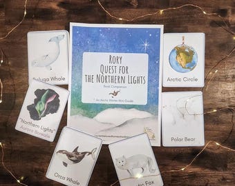 May include: A collection of educational materials featuring a book titled "Rory Quest for the Northern Lights" and flashcards with illustrations of Arctic animals like the beluga whale, orca whale, and arctic fox. The flashcards also include the Arctic Circle and the Northern Lights.