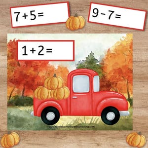 May include: A fall-themed educational image with math problems and a red truck carrying pumpkins. The image includes the equations 7+5=, 9-7=, and 1+2=, along with decorative pumpkins and autumn foliage. The website address www.fortheloveofhomeschooling.com is visible.